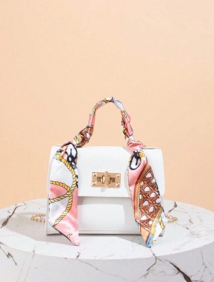 Printed faux leather bag with a chain and scarf detail