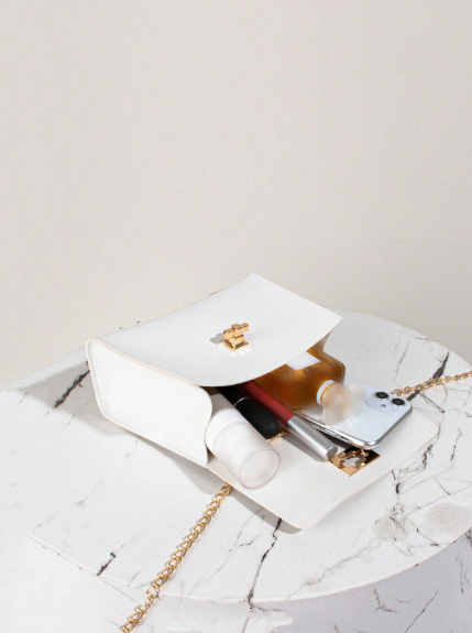 Printed faux leather bag with a chain and scarf detail